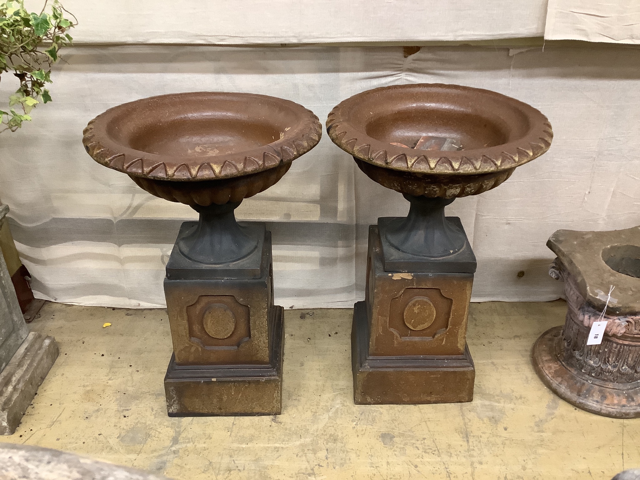 A pair of glazed stoneward garden urns on pedestals, height 79cm, diameter 51cm